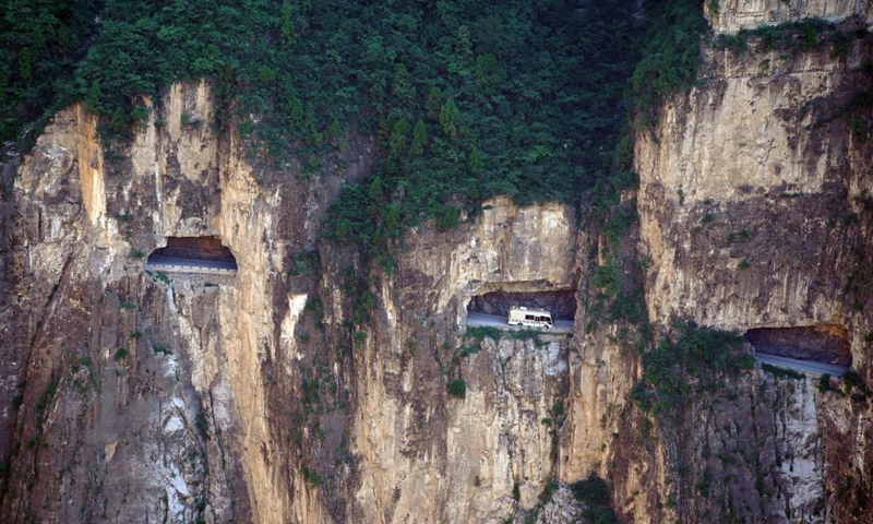 A vehicle runs on the road over the cliff in Pingshun County, north China's Shanxi Province, July 9, 2021. Tucked away in the steep Taihang Mountain, Shenlongwan Village of Pingshun County has long suffered from poor transport infrastructure due to the rugged mountainous terrain.Photo:Xinhua