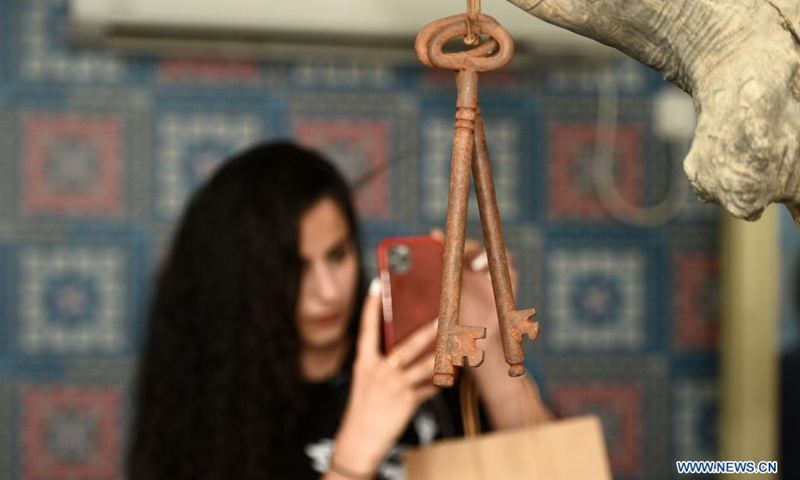 A woman takes photos during an art event in Ahmadi Governorate, Kuwait, on July 10, 2021. Artists, activists and entrepreneurs in Kuwait held an art event on Saturday to raise money for and express solidarity with the Palestinian people. (Photo: Xinhua)