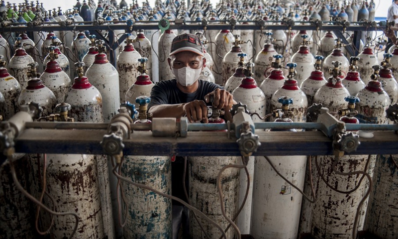 A worker wearing a face mask is seen among medical oxygen tanks in Yogyakarta, Indonesia, July 7, 2021.(Photo: Xinhua)