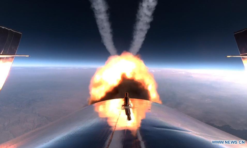 Photo released by Virgin Galactic on July 11, 2021 shows the company's spacecraft VSS Unity rocket motor burn on Unity 22. Space tourism company Virgin Galactic completed its first fully crewed test flight of its spacecraft on Sunday, making a giant leap toward commercial suborbital spaceflight. The mission, dubbed Unity 22, was the company's fourth crewed spaceflight, and the 22nd flight test for the company's spacecraft VSS Unity.(Photo: Xinhua)