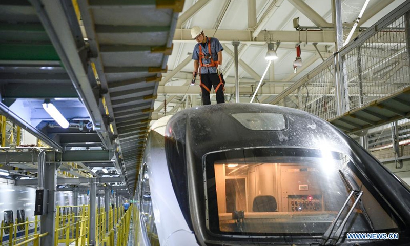 A mechanic inspects a bullet train at a maintenance base in Yinchuan, northwest China's Ningxia Hui Autonomous Region, July 11, 2021. China Railway Lanzhou Bureau Group Co., Ltd. has carried out maintenance work for trains on a daily basis to ensure train safety in the summer heat.(Photo: Xinhua)