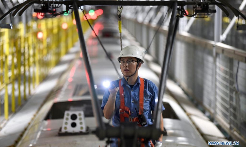 A mechanic inspects a bullet train's overhead contact system at a maintenance base in Yinchuan, northwest China's Ningxia Hui Autonomous Region, July 11, 2021. China Railway Lanzhou Bureau Group Co., Ltd. has carried out maintenance work for trains on a daily basis to ensure train safety in the summer heat. (Photo: Xinhua)
