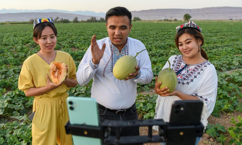 People promote Hami melons via livestreaming in Turpan of northwest China's Xinjiang Uygur Autonomous Region, May 19, 2021.Photo:Xinhua