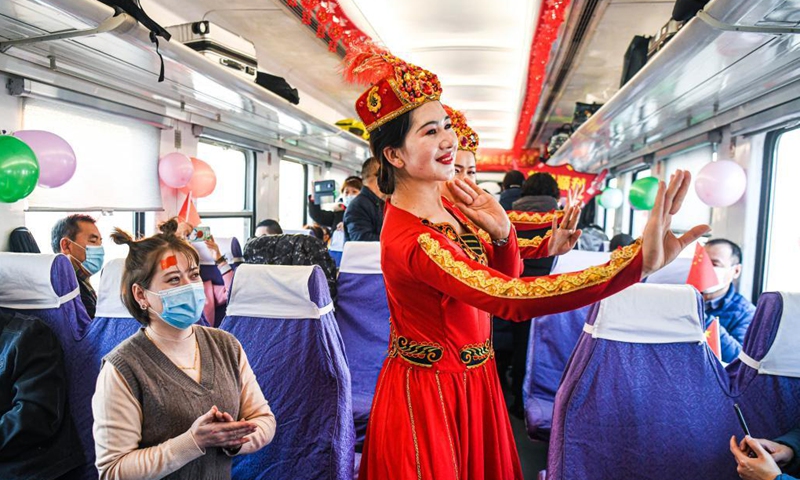 Staff members and passengers dance together in a passenger car of train No. K9756 from Korla to Yetimbulak in northwest China's Xinjiang Uygur Autonomous Region, Dec. 9, 2020.Photo:Xinhua