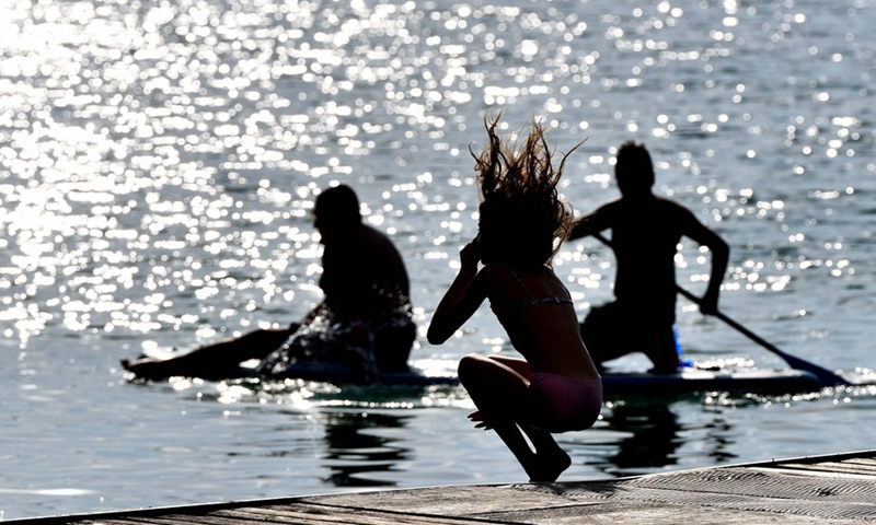 People enjoy their leisure time at Ohrid Lake in Ohrid, North Macedonia on July 16, 2021.(Photo: Xinhua)
