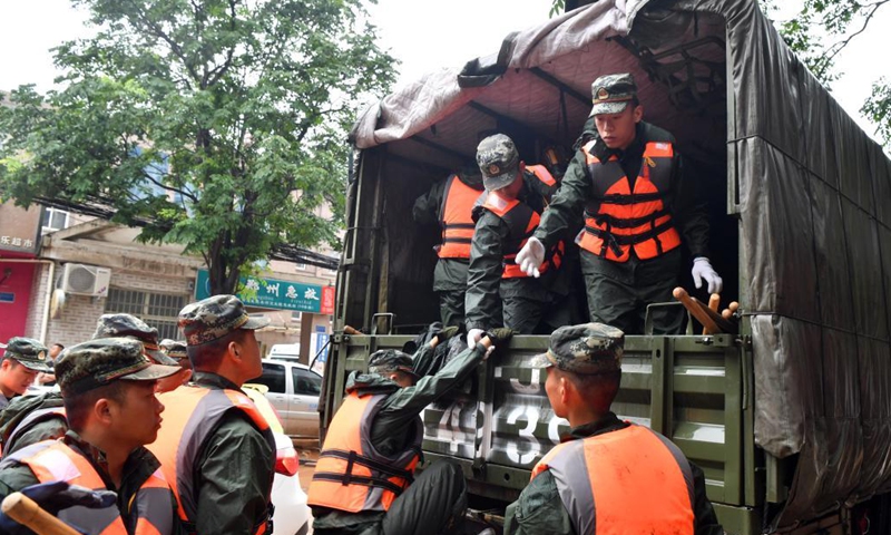 Armed police officers prepare to depart for rescue work in Mihe Town of Gongyi City, central China's Henan Province, July 21, 2021. Mihe Town suffered great damage due to the heavy rainfall on July 20, with a large number of roads damaged and vehicles flooded.(Photo: Xinhua)