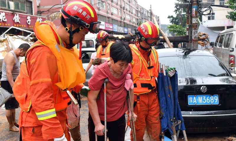 People are transferred to a safe place in Mihe Town of Gongyi City, central China's Henan Province, July 21, 2021. Mihe Town suffered great damage due to the heavy rainfall on July 20, with a large number of roads damaged and vehicles flooded. (Photo: Xinhua)