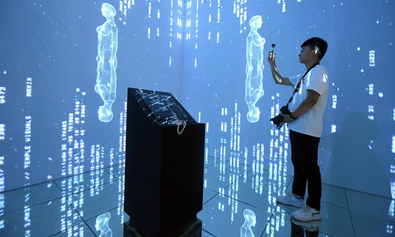 A visitor is seen at the 2021 Asia Digital Art Exhibition at the Times Art Museum in Beijing, capital of China, July 23, 2021. Photo:Xinhua