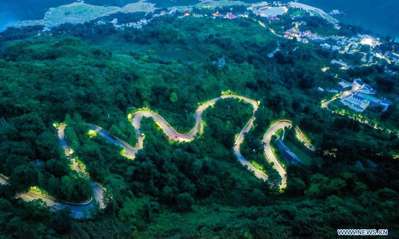 Aerial photo taken on July 23, 2021 shows a road leading to Huawu Village in Xinren Miao Township, Qianxi City, southwest China's Guizhou Province. Huawu Village, although boasting unique ethnic Miao culture and splendid mountain views with vast water bodies, once had a poverty headcount ratio as high as 63.6 percent.(Photo: Xinhua)