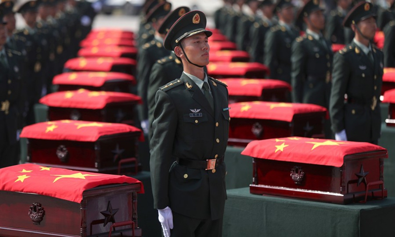 Caskets containing the remains of 117 Chinese soldiers killed in the 1950-53 Korean War are escorted by honor guards at the Taoxian international airport in Shenyang, northeast China's Liaoning Province, Sept. 27, 2020. (Photo: Xinhua)