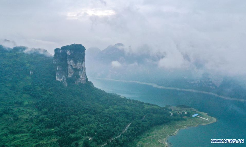 Aerial photo taken on July 24, 2021 shows an early morning view of Huawu Village in Xinren Miao Township, Qianxi City, southwest China's Guizhou Province. Huawu Village, although boasting unique ethnic Miao culture and splendid mountain views with vast water bodies, once had a poverty headcount ratio as high as 63.6 percent.(Photo: Xinhua)