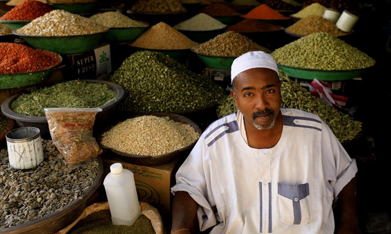 A vendor sells products at a local market in Khartoum, Sudan, March 16, 2021.(Photo: Xinhua)