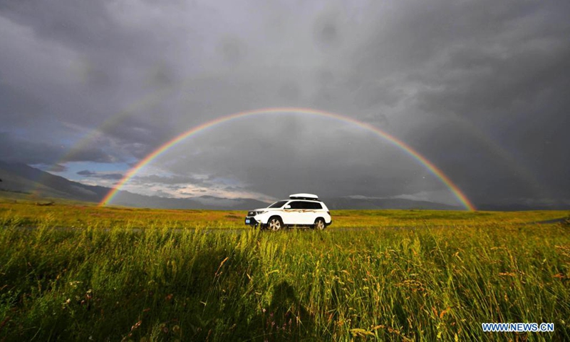 Photo taken on July 24, 2021 shows a rainbow arching across the sky in Hemu Village of Kanas in Altay, northwest China's Xinjiang Uygur Autonomous Region. The Kanas scenic area, which is at the height of the tourist season, received over 6.2 million tourists from May 1 to July 27, according to the local authority.(Photo: Xinhua)
