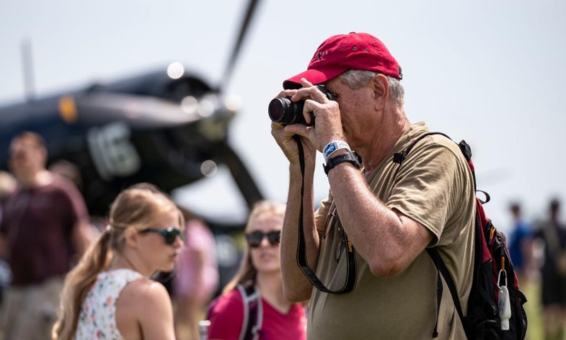 A man takes photos at the Experimental Aircraft Association (EAA) AirVenture 2021 in Oshkosh, Wisconsin, the United States, July 30, 2021. The EAA AirVenture, an annual air show that gathering aviation enthusiasts, is ongoing from July 26 to Aug. 1, 2021.Photo:Xinhua