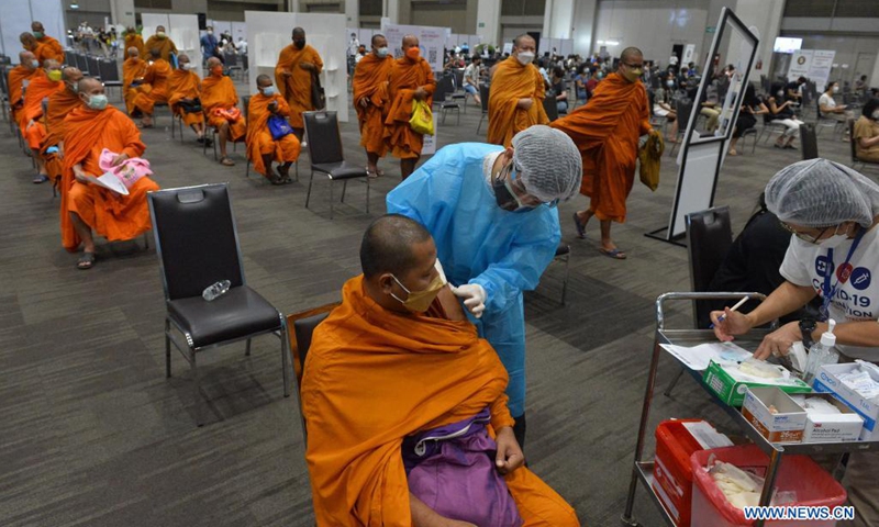 A Thai Buddhist receives a dose of the COVID-19 vaccine in Bangkok, Thailand, on July 31, 2021. Thailand's daily COVID-19 cases and deaths both set records again on Saturday, as the country fights its worst surge in infections driven by the highly contagious Delta variant.(Photo: Xinhua)