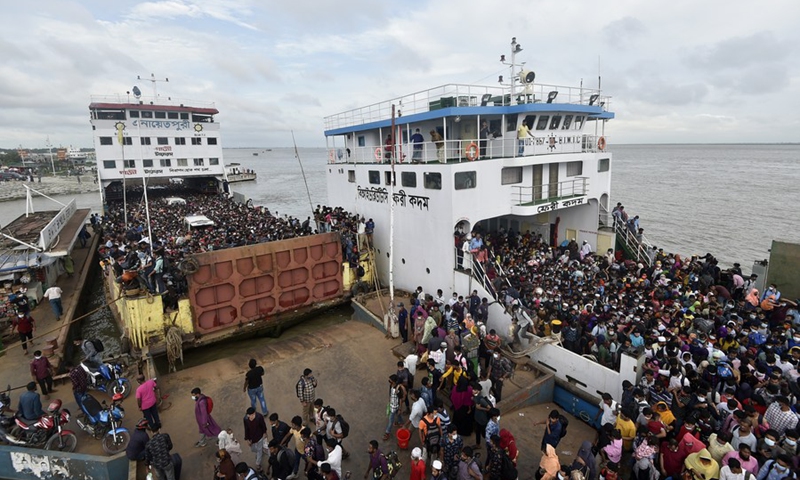 Two ferries are seen full of passengers at a terminal in Munshiganj on the outskirts of Dhaka, Bangladesh, on July 31, 2021. (Photo: Xinhua)