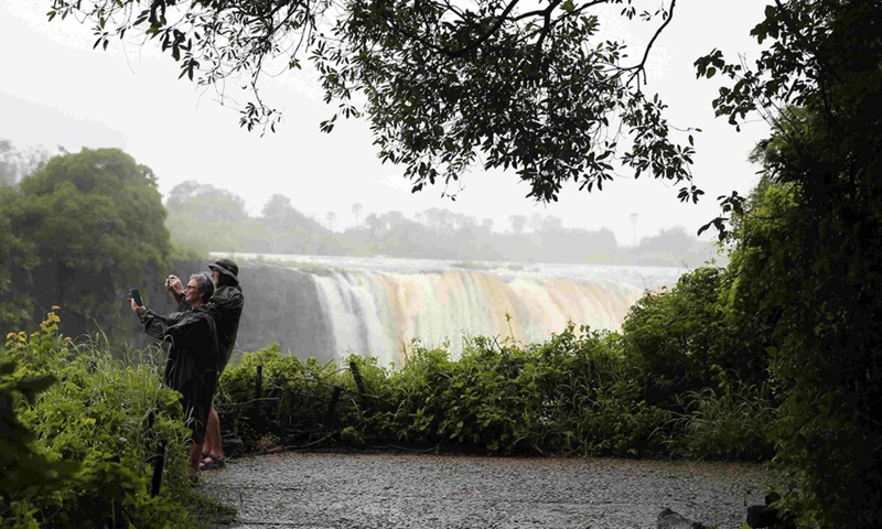 Tourists take photos in Victoria Falls National Park, Hwange District, north western Zimbabwe, Feb. 26, 2020.(Photo: Xinhua)
