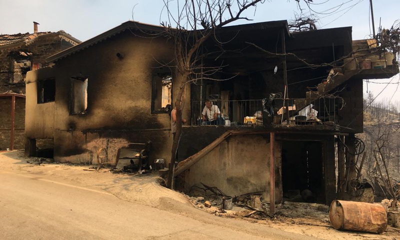 A house is seen burned by wildfires near Manavgat, a resort town of Antalya province, Turkey, on Aug. 2, 2021. Turkey has been battling wildfires that erupted in the southern and southwestern coastal resort towns and have lasted six days, officials announced Monday. Turkish Agriculture and Forestry Minister Bekir Pakdemirli pointed out that the fire in Manavgat continues and has the potential to cause new evacuations.(Photo: Xinhua)