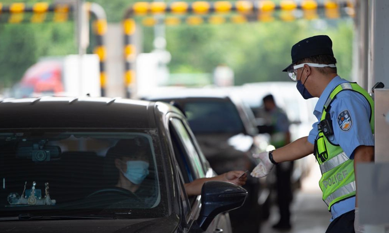 Policemen check information of people entering Beijing at a road checkpoint in Beijing, capital of China, Aug. 6, 2021.Photo:Xinhua