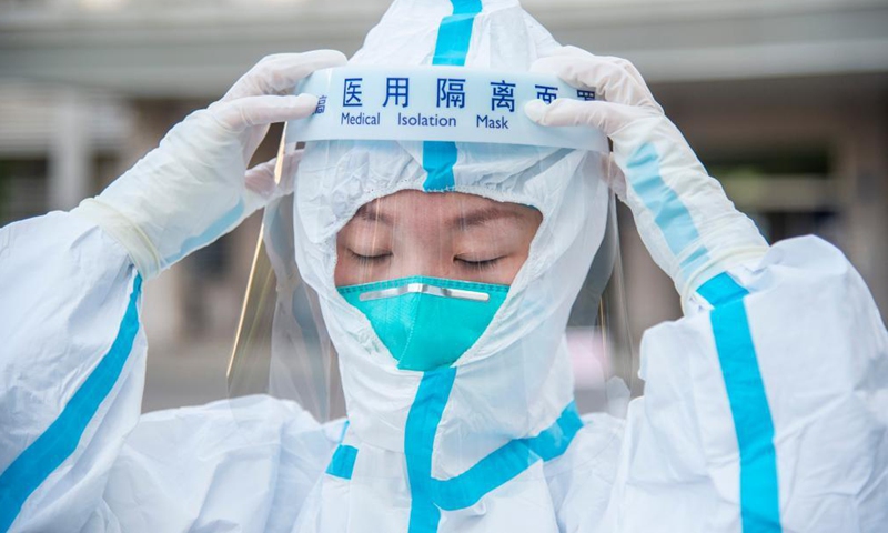 Nurse Zhang Xianghan takes a swab sample from a resident for COVID-19 nucleic acid testing in Wuhan, central China's Hubei Province, Aug. 6, 2021.Photo:Xinhua