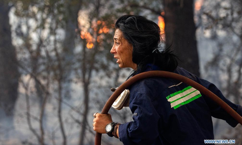 A firefighter tries to put out a fire in Afidnes, some 30 kilometers away from the Greek capital of Athens, on Aug. 6, 2021. Greek authorities said on Friday that three people have been arrested for suspected arson, as devastating wildfires continue to scorch thousands of hectares of forest land across the country.Photo:Xinhua