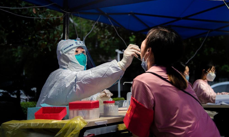 Nurse Zhang Xianghan takes a swab sample from a resident for COVID-19 nucleic acid testing in Wuhan, central China's Hubei Province, Aug. 6, 2021.Photo:Xinhua