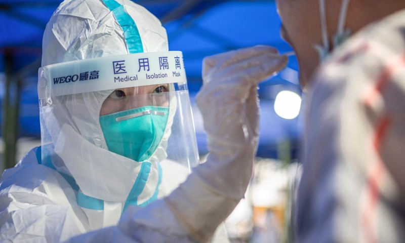 Nurse Han Miaomiao takes a swab sample from a resident for COVID-19 nucleic acid testing in Wuhan, central China's Hubei Province, Aug. 4, 2021.Photo:Xinhua