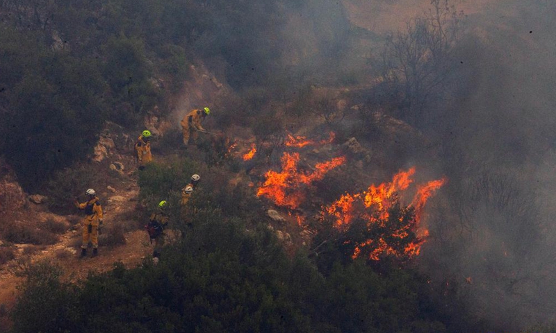 Firefighters try to put out a fire in Afidnes, some 30 kilometers away from the Greek capital of Athens, on Aug. 6, 2021. Greek authorities said on Friday that three people have been arrested for suspected arson, as devastating wildfires continue to scorch thousands of hectares of forest land across the country.Photo:Xinhua