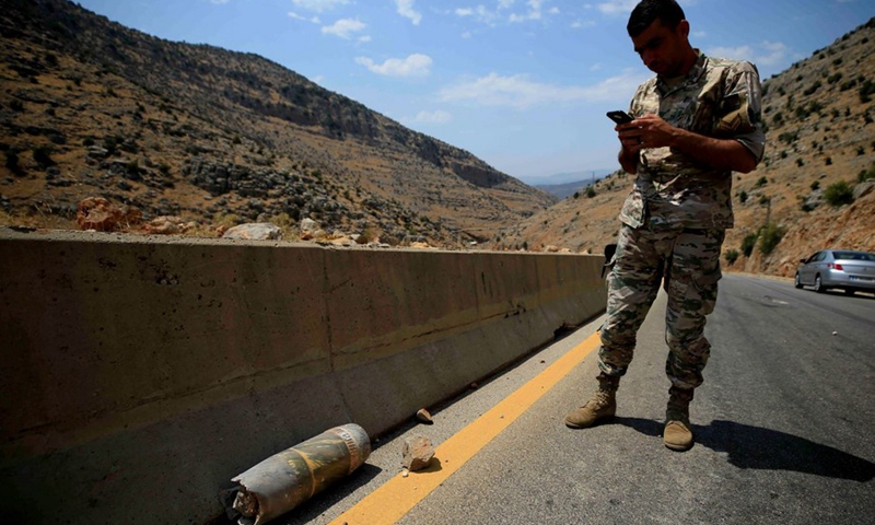 A Lebanese soldier examines the remains of an Israeli shell that fell on the road to the town of Shebaa, south Lebanon, on Aug. 6, 2021.(Photo: Xinhua)