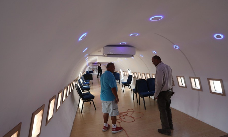 Palestinian Khamis al-Sairafi (left) stands inside the Boeing 707 converted into a restaurant in the West Bank city of Nablus on July 25, 2021 (Photo: Xinhua)