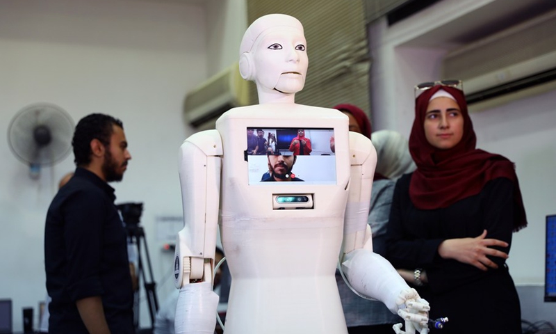 Students and teaching staff show the video call ability of their created robot nurse Shams in a lab of Ain Shams University in Cairo, Egypt, on Aug. 11, 2021.(Photo: Xinhua)