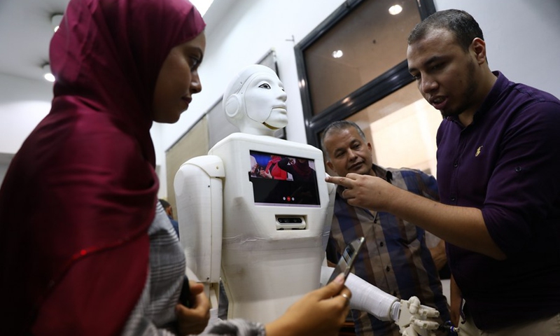 Students and teaching staff show the video call ability of their created robot nurse Shams in a lab of Ain Shams University in Cairo, Egypt, on Aug. 11, 2021.(Photo: Xinhua)