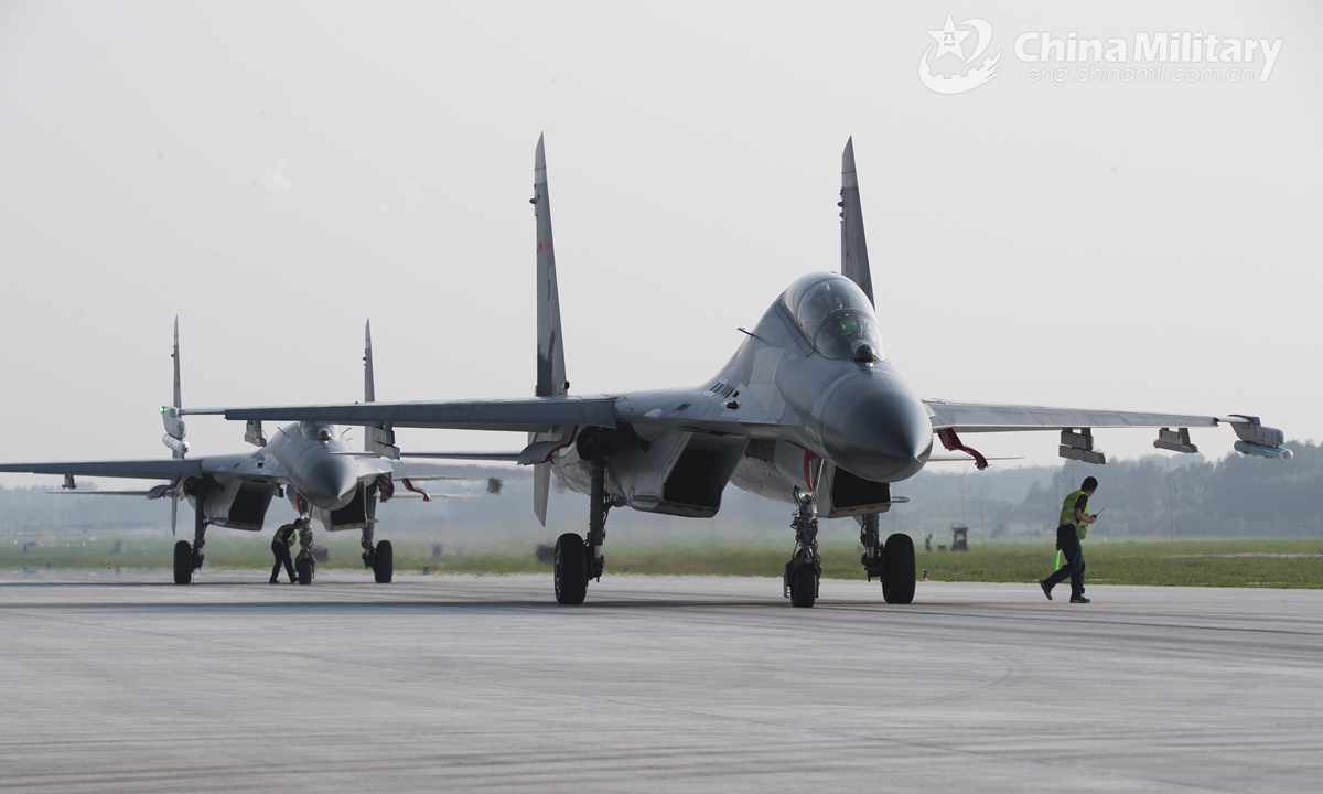 Fighter jets attached to an aviation brigade of the air force under the PLA Eastern Theater Command taxi in formation to the servicing depot for inspections prior to a flight training exercise on July 31, 2021.Photo:China Military