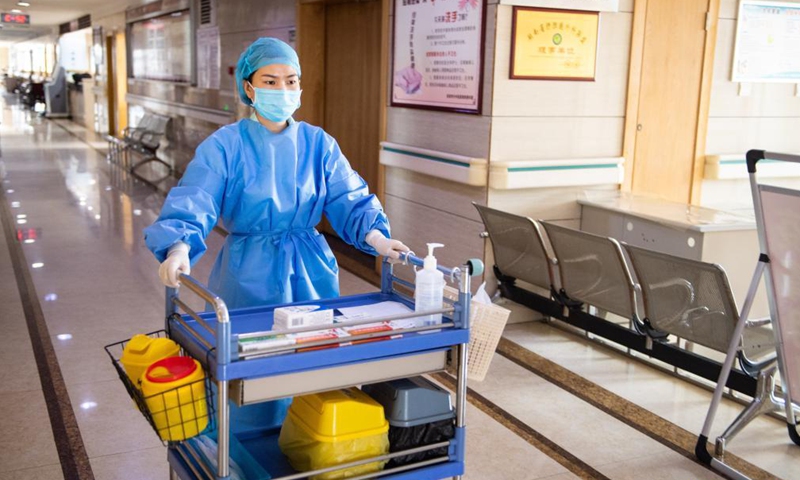 Xiang Ka walks to distribute medicines to patients at the Zhangjiajie Hospital of Traditional Chinese Medicine in Zhangjiajie City, central China's Hunan Province, Aug. 13, 2021.Photo:Xinhua
