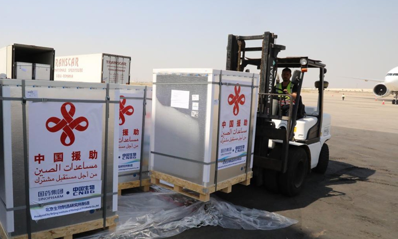 Workers transport COVID-19 vaccines at Baghdad International Airport in Iraq on Aug. 12, 2021. Iraq on Thursday received a third batch of COVID-19 vaccines donated by the Chinese government amid a surge in coronavirus infections due to the spread of the Delta variant.Photo:Xinhua