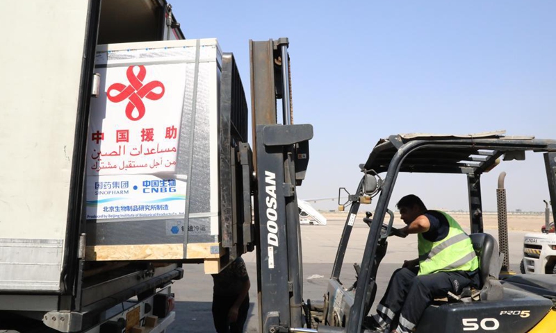 Workers transport COVID-19 vaccines at Baghdad International Airport in Iraq on Aug. 12, 2021. Iraq on Thursday received a third batch of COVID-19 vaccines donated by the Chinese government amid a surge in coronavirus infections due to the spread of the Delta variant.Photo:Xinhua