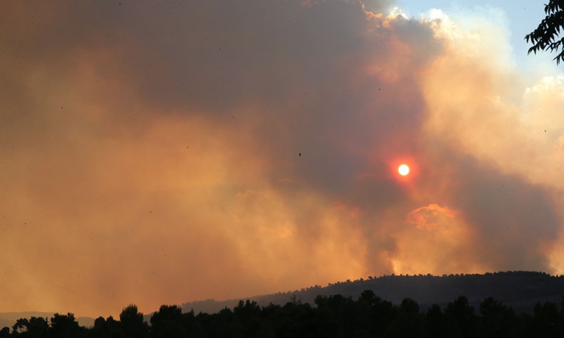 Black smoke and ash from a massive wildfire cloud the sky near Jerusalem, on Aug. 15, 2021.(Photo: Xinhua)