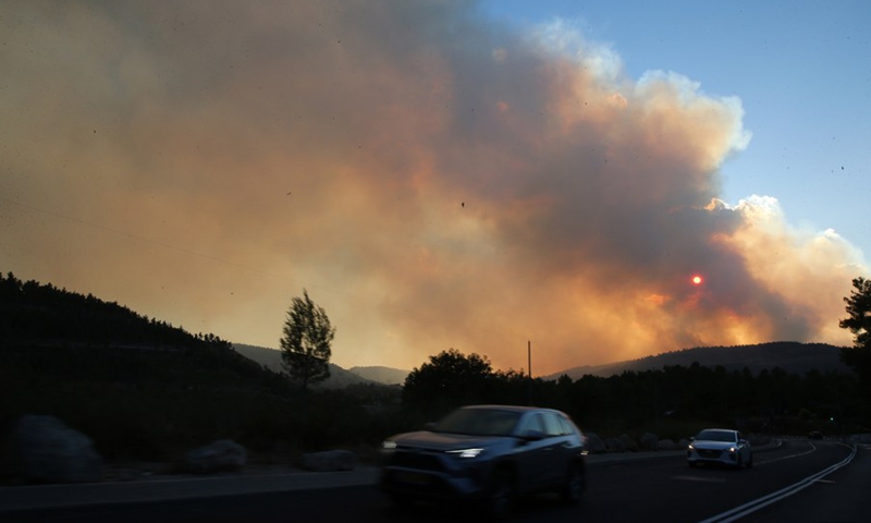 Black smoke and ash from a massive wildfire cloud the sky near Jerusalem, on Aug. 15, 2021.(Photo: Xinhua)