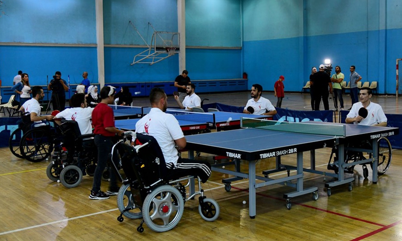 Syrian veterans with physical impairment play table tennis at a training camp in Damascus, Syria, on Aug. 16, 2021.(Photo: Xinhua)