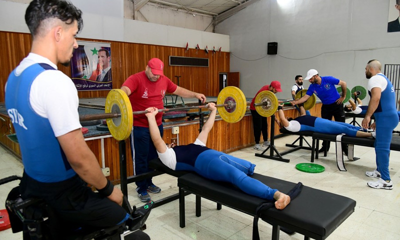 Syrian veterans with physical impairment receive weightlifting trainings at a training camp in Damascus, Syria, on Aug. 16, 2021.(Photo: Xinhua)