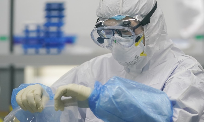 A staff member handles nucleic acid testing samples at a novel coronavirus detection lab in Wuhan, central China's Hubei Province, Feb. 22, 2020.Photo:Xinhua