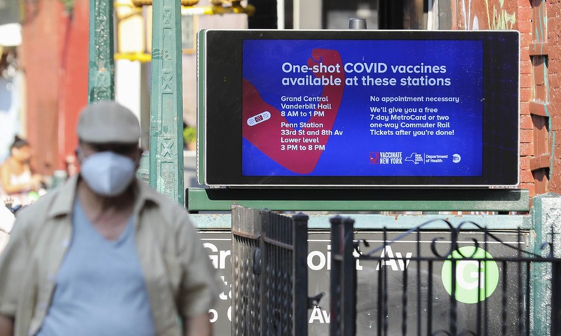A pedestrian walks past a COVID-19 vaccine inoculation billboard in New York, the United States, July 26, 2021.Photo:Xinhua