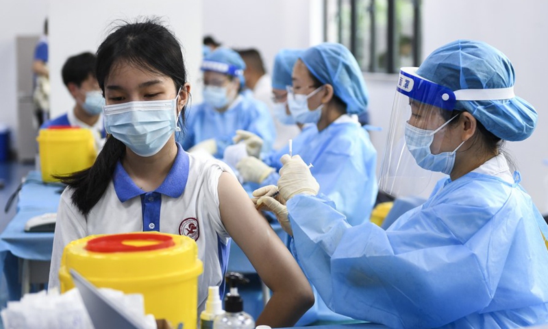 A medical worker administers a dose of COVID-19 vaccine for a student at a high school in Shenzhen, south China's Guangdong Province, July 29, 2021.Photo:Xinhua