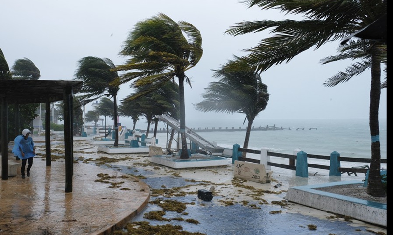 A person walks in the rain caused by the landfall of Hurricane Grace in Puerto Morelos, Quintana Roo, Mexico, on Aug. 19, 2021.(Photo: Xinhua)