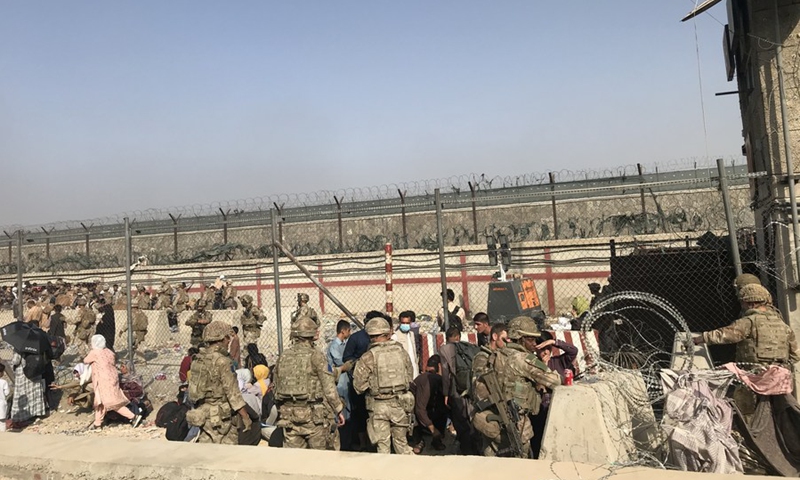 Afghans enter Kabul airport in Kabul, Afghanistan, Aug. 22, 2021. Seven Afghan civilians were killed amid chaos near the Kabul airport as people swarmed the area in hopes of boarding an evacuation flight following the Taliban takeover of Afghanistan, Britain's Ministry of Defense said Sunday.(Photo: Xinhua)