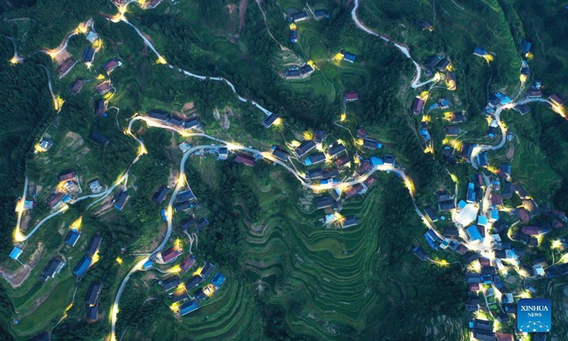 Aerial photo taken on Aug. 27, 2021 shows solar powered street lamps lighted up along a road in Weizhou Township of Beihai City, south China's Guangxi Zhuang Autonomous Region. More and more solar powered street lamps have been erected in areas tucked away in the mountains in Guangxi, illuminating the night sky for people living there.Photo:Xinhua