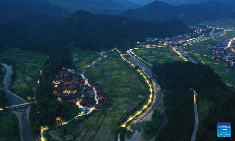 Aerial photo taken on Aug. 24, 2021 shows solar powered street lamps lighted up along roads in Dongtou Village of Rongshui Miao Autonomous County, south China's Guangxi Zhuang Autonomous Region. More and more solar powered street lamps have been erected in areas tucked away in the mountains in Guangxi, illuminating the night sky for people living there.Photo:Xinhua