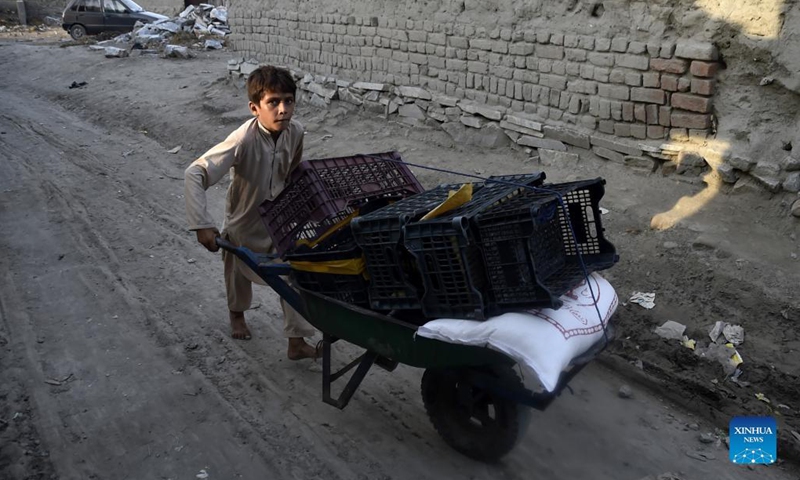 An Afghan refugee child pushes a cart at a refugee camp in northwest Pakistan's Peshawar on Aug. 28, 2021. Pakistan currently hosts more than 1.4 million registered Afghan refugees who have been forced to flee their homes, according to the United Nations High Commissioner for Refugees (UNHCR).(Photo: Xinhua)
