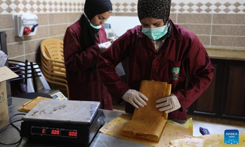 Women work at the Dora Cooperative Association for Agricultural Industrial, in the West Bank village of Dura near Hebron, on Aug. 26, 2021.Photo:Xinhua