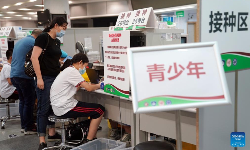 A girl registers before receiving a dose of the COVID-19 vaccine at a vaccination site in Xuhui District of Shanghai, east China, Sept. 3, 2021. Shanghai kicked off a mass vaccination campaign to minors aged between 12 and 14 on Friday.Photo:Xinhua